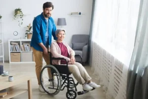 Caregiver assisting a woman who uses a wheelchair