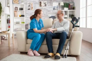 Doctor and older man smiling at each other during a care visit