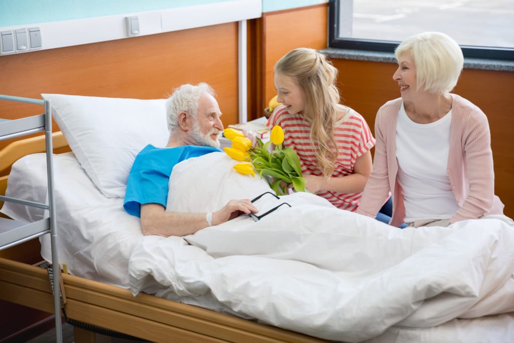 Hospice care provider comforting an elderly patient by holding hands, symbolizing support and compassion in end-of-life care.