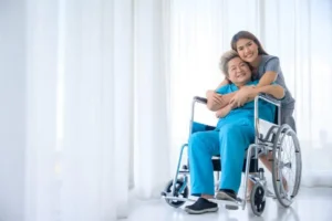 Patient holding a caregiver's hand while smiling