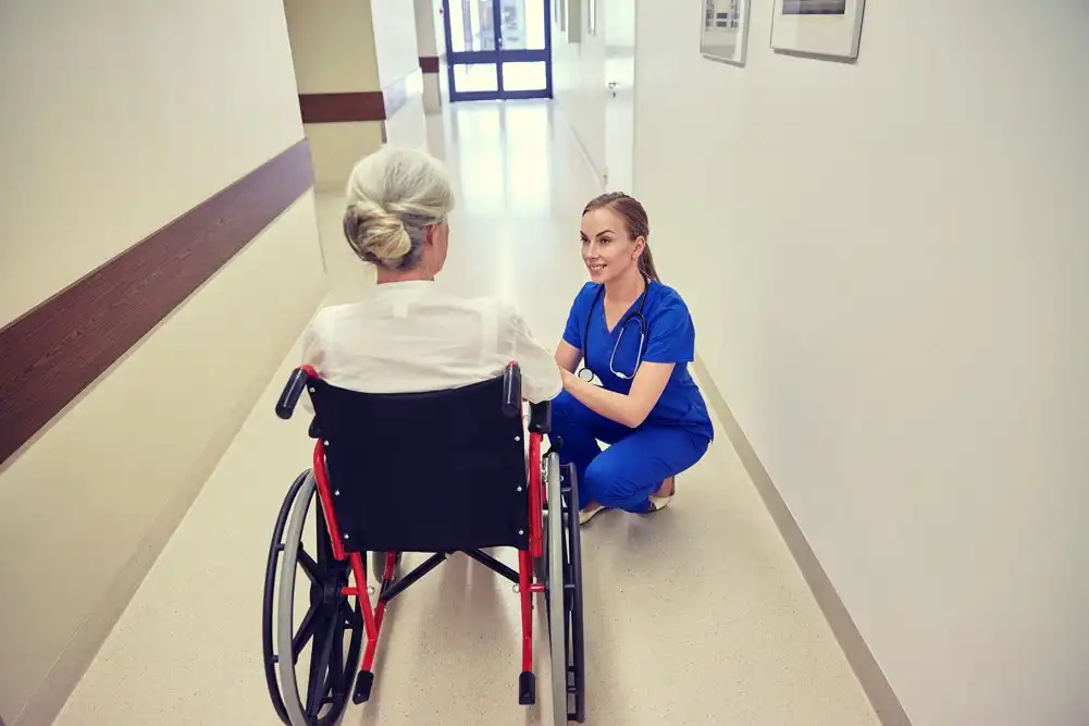 Hospice care nurse talking with a patient to provide emotional support.