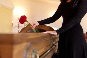 Woman holding red roses at a funeral