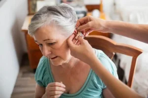 Hospice caregiver helping an older patient at home
