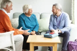Hospice nurse explaining care options to an older patient and family