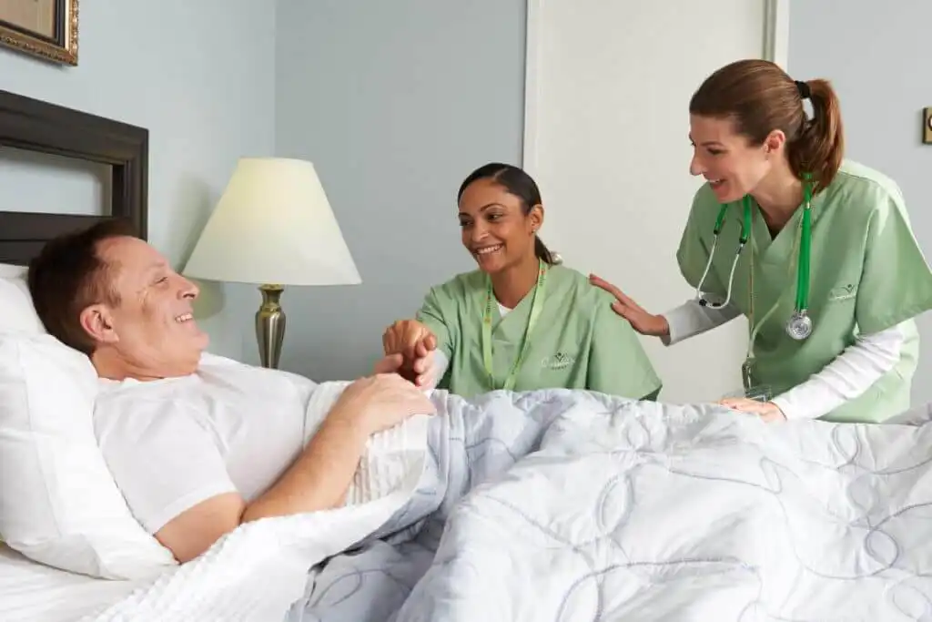A compassionate hospice nurse provides care and comfort to a patient