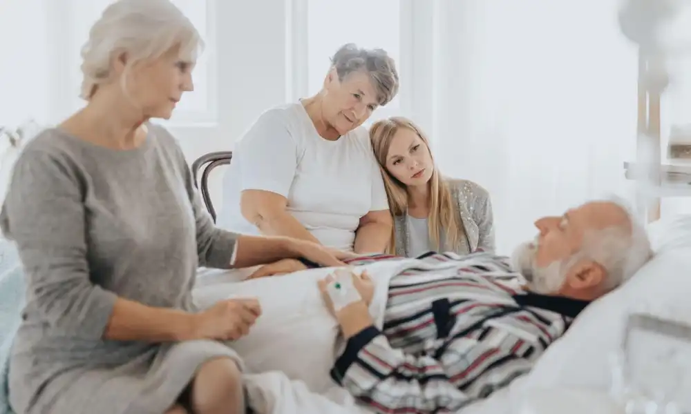Hospice caregiver holding patient hand for comfort