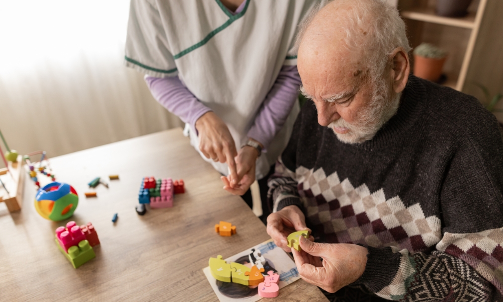 Hospice nurse supporting patient with advanced dementia and family