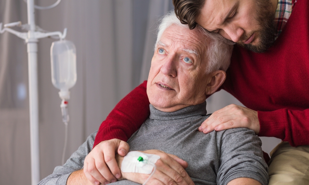 Patient in bed with family offering emotional support during hospice care