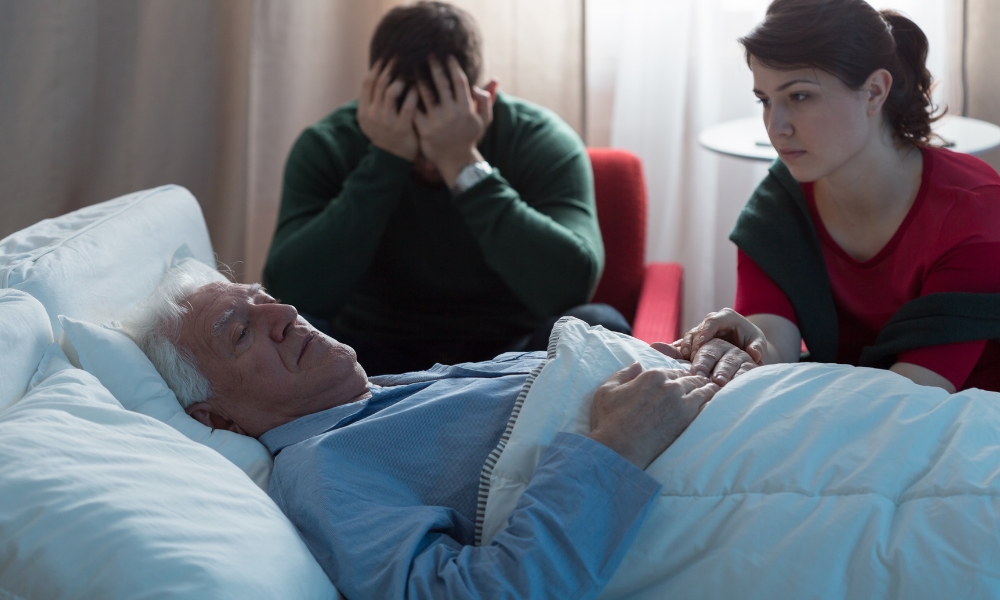 Patient in bed with family offering emotional support