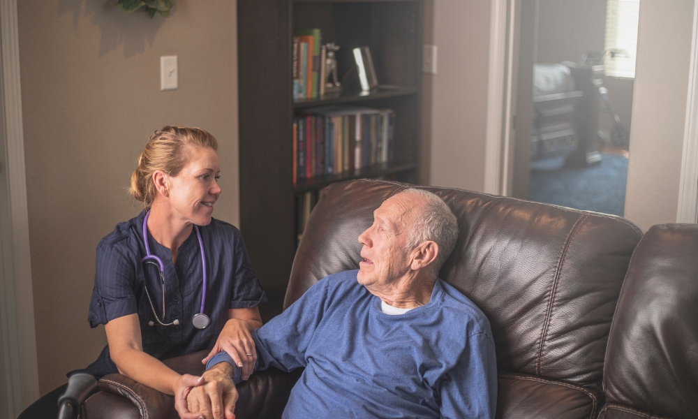 Family discussing care options with medical professional in home setting