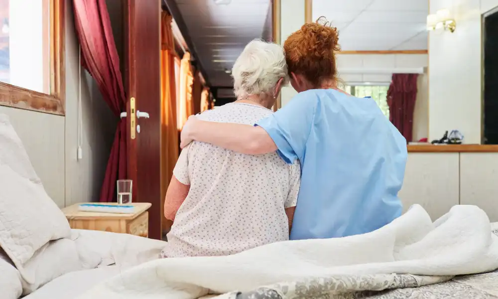 Hospice nurse providing care and support to patient at home